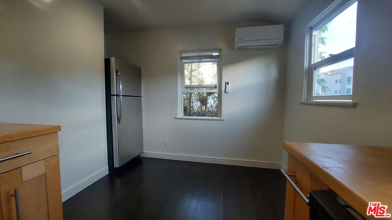 2140 20th Street, Unit A Santa Monica, CA 90405 - Photo 7 of 15 an empty room with wooden floor and windows