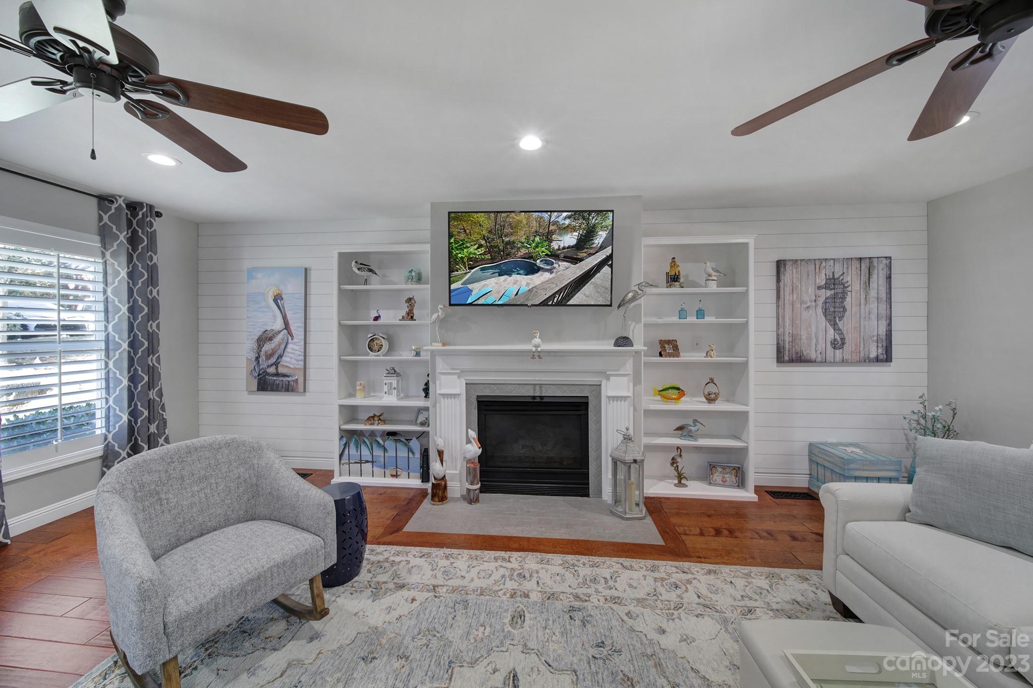 4028 Windward Drive Tega Cay, SC 29708 - Photo 12 of 48 a living room with furniture a flat screen tv and a fireplace