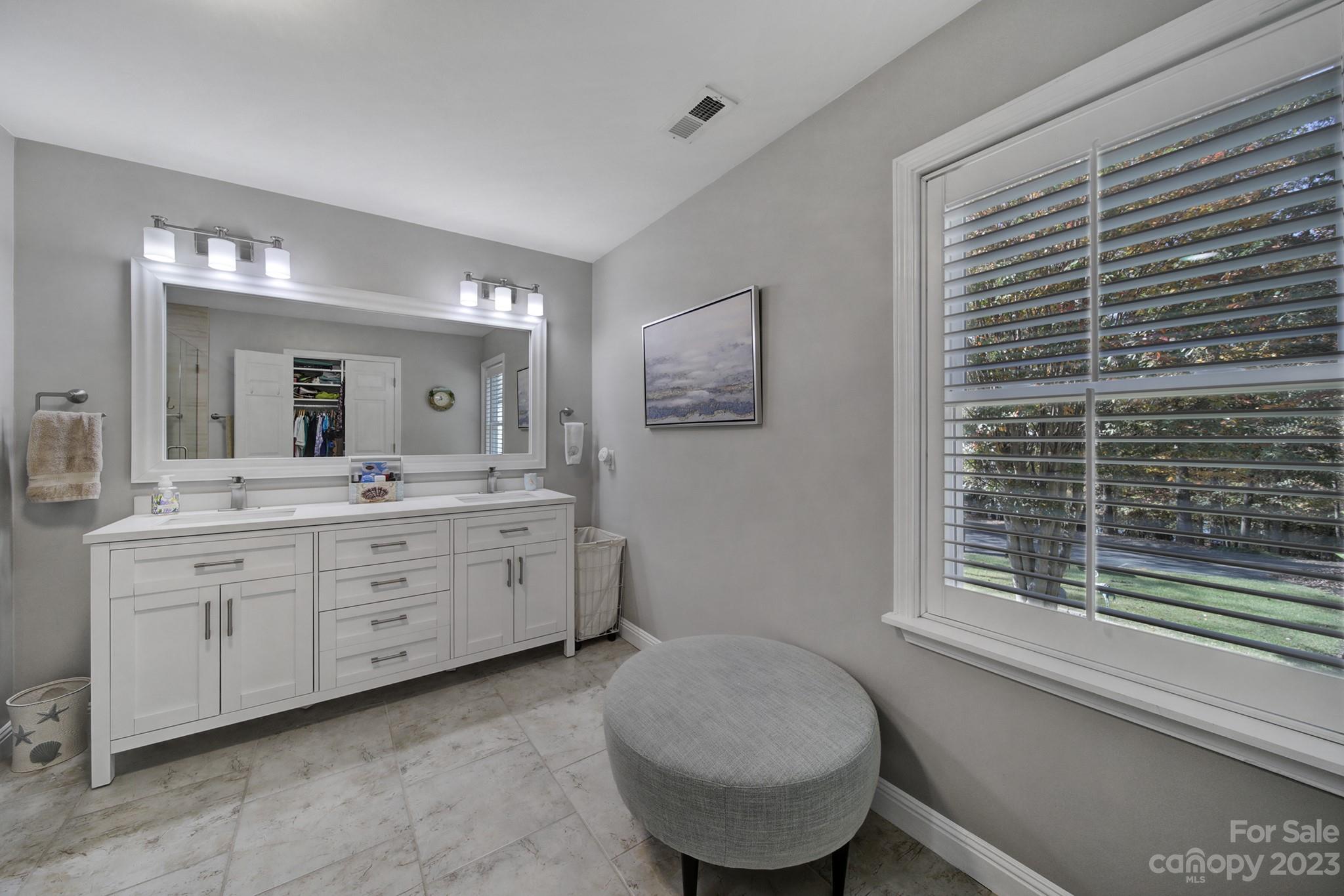 4028 Windward Drive Tega Cay, SC 29708 - Photo 25 of 48 a spacious bathroom with a granite countertop sink mirror and a toilet