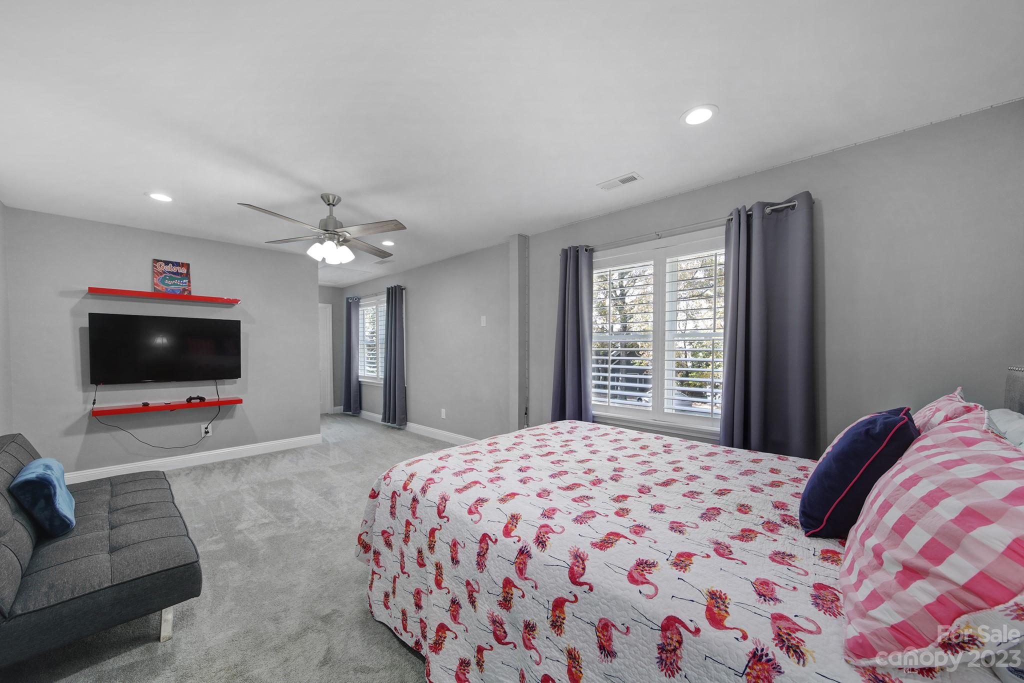 4028 Windward Drive Tega Cay, SC 29708 - Photo 27 of 48 a bedroom with a bed and a flat screen tv