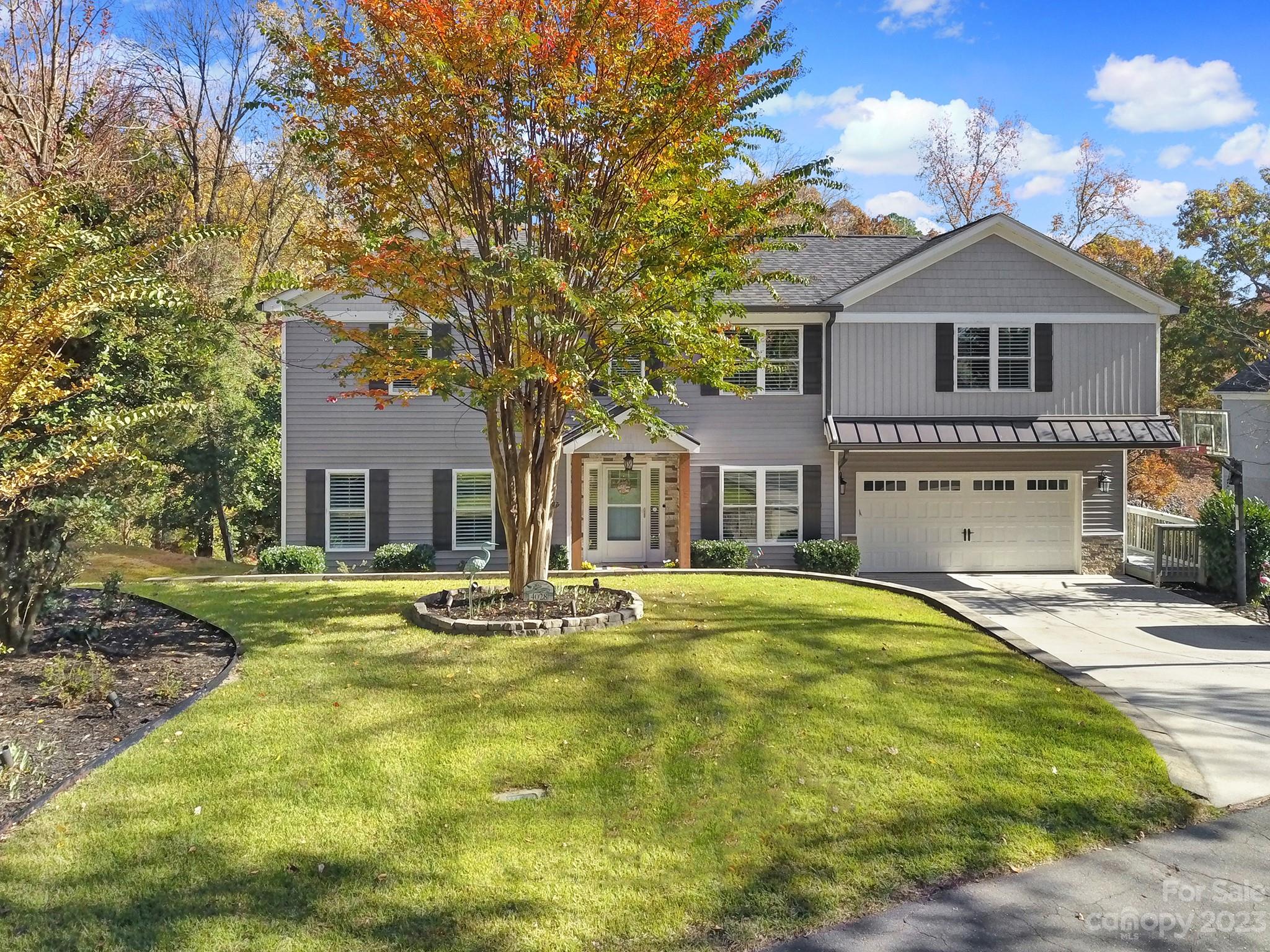 4028 Windward Drive Tega Cay, SC 29708 - Photo 5 of 48 a front view of a house with a garden