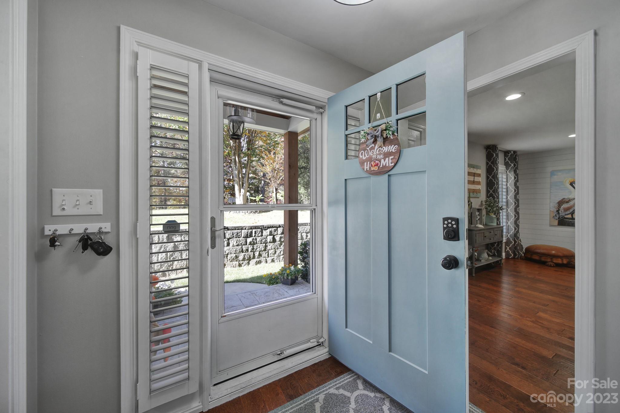 4028 Windward Drive Tega Cay, SC 29708 - Photo 6 of 48 a view of a hallway with a door and wooden floor