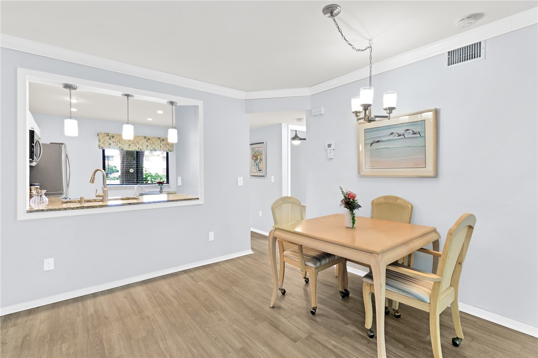 9645 Estuary Way, Unit 1 Sebastian, FL 32958 - Photo 13 of 36 a view of a dining room with furniture and wooden floor