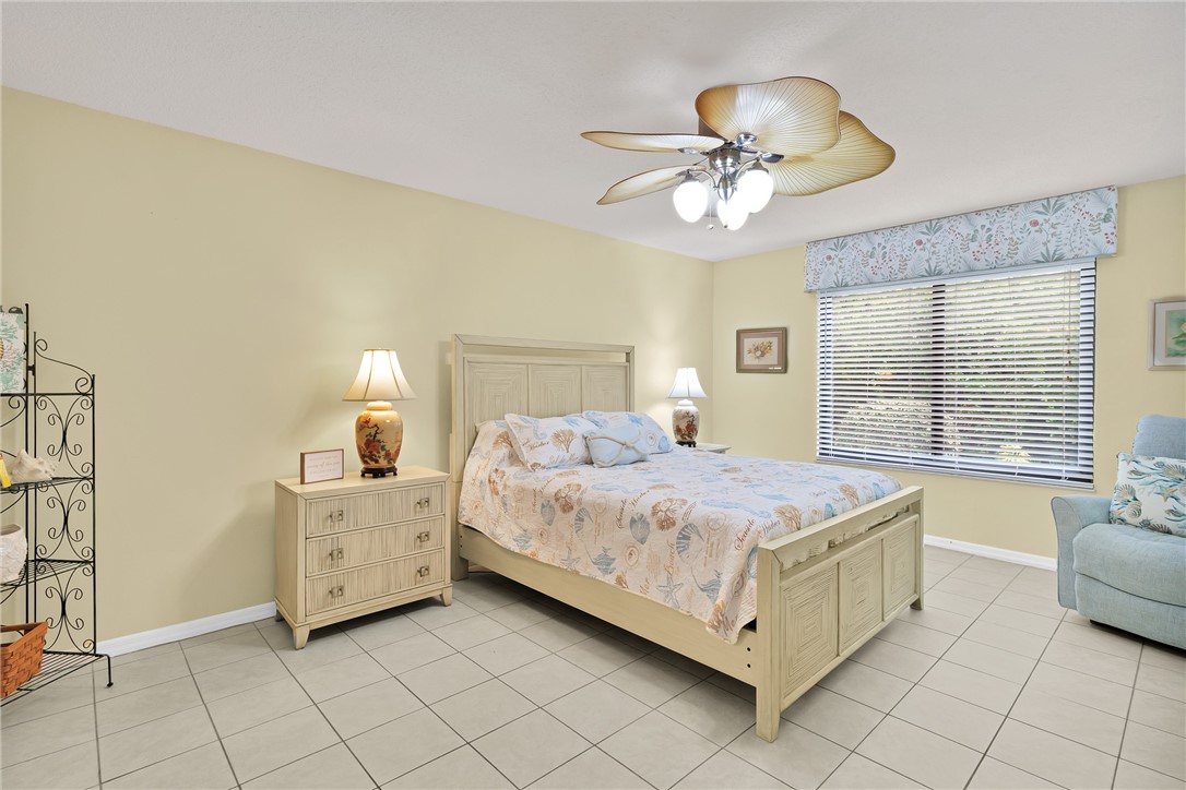9645 Estuary Way, Unit 1 Sebastian, FL 32958 - Photo 15 of 36 a bed room with a bed and a chandelier
