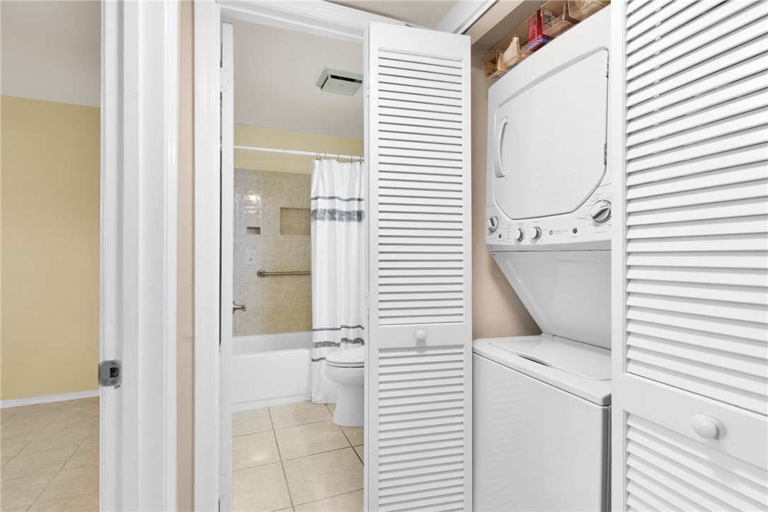 9645 Estuary Way, Unit 1 Sebastian, FL 32958 - Photo 20 of 36 a bathroom with a sink a mirror and a shower