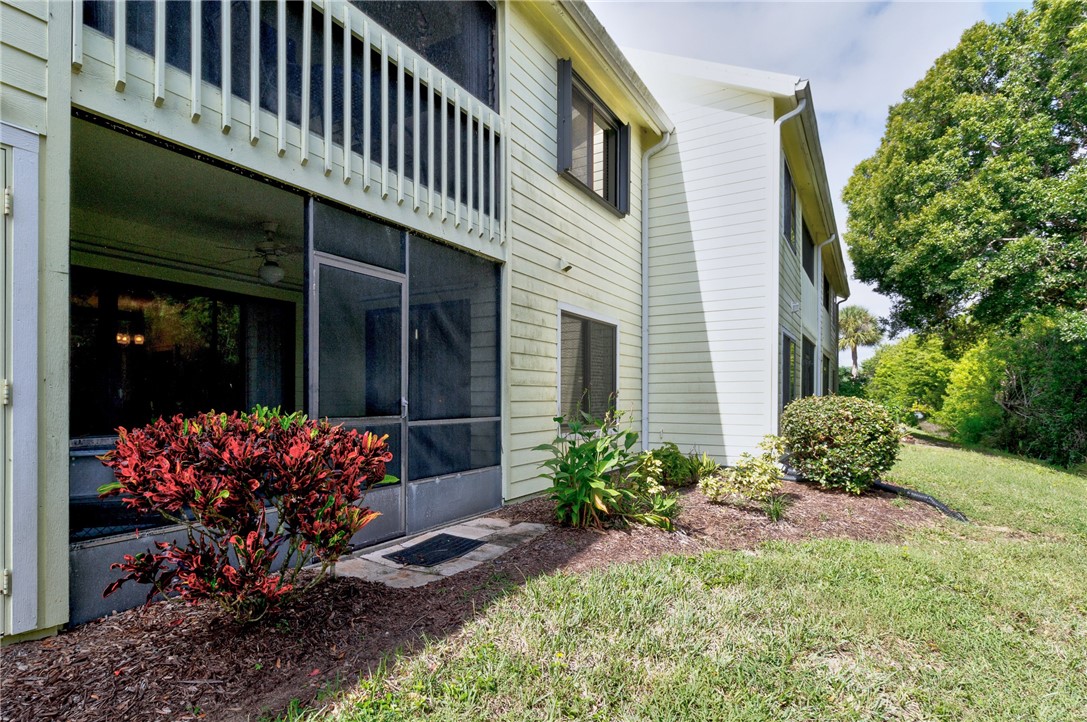 9645 Estuary Way, Unit 1 Sebastian, FL 32958 - Photo 26 of 36 a front view of a house with a garden