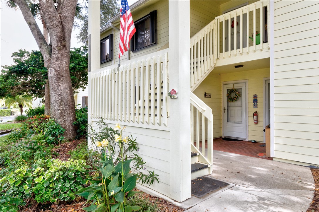 9645 Estuary Way, Unit 1 Sebastian, FL 32958 - Photo 3 of 36 a view of a house with a small yard and plants