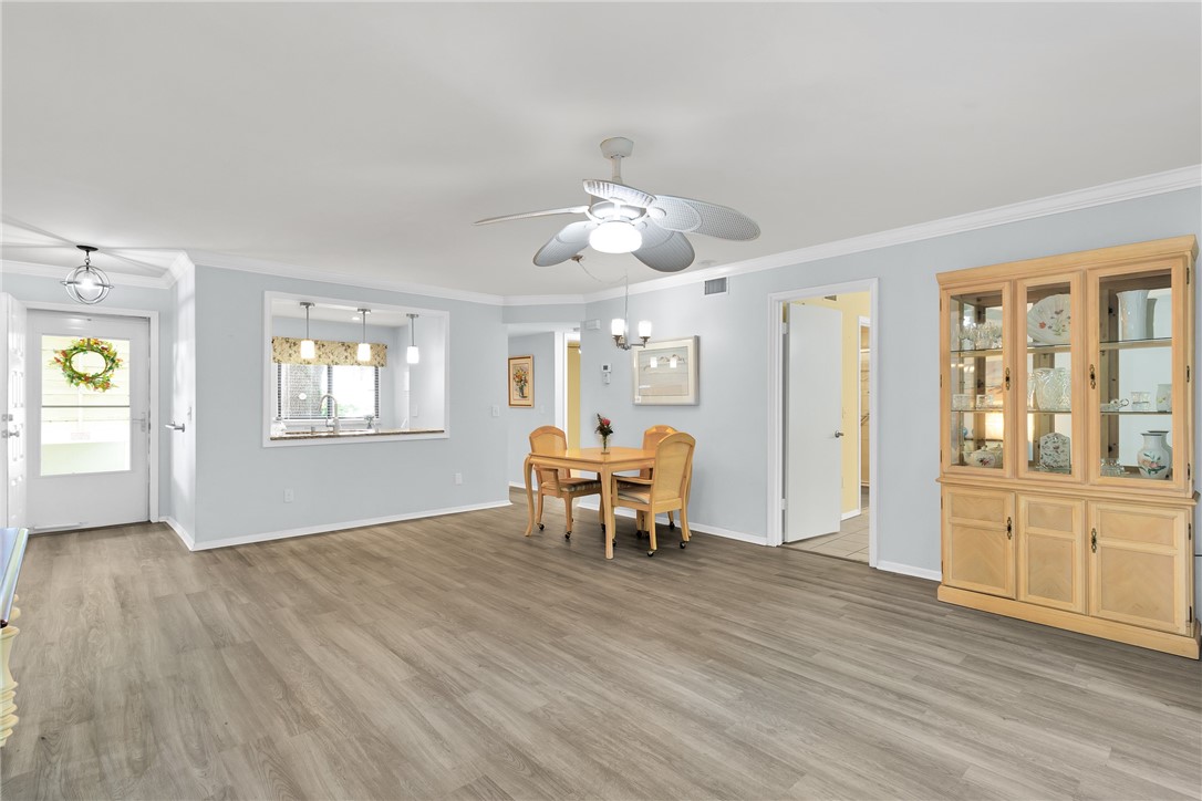 9645 Estuary Way, Unit 1 Sebastian, FL 32958 - Photo 5 of 36 wooden floor in an empty room with a window