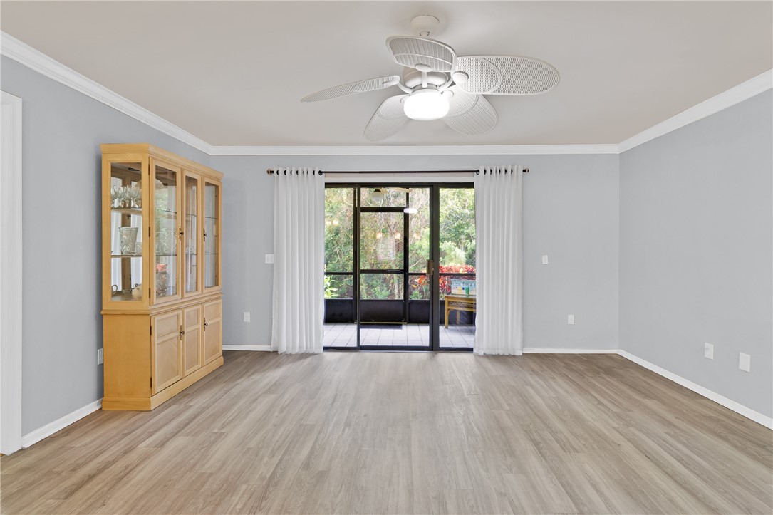 9645 Estuary Way, Unit 1 Sebastian, FL 32958 - Photo 7 of 36 an empty room with wooden floor and windows