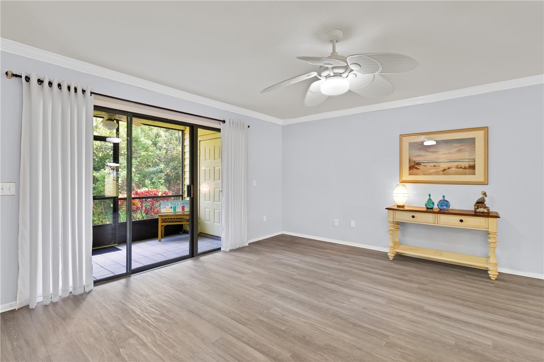 9645 Estuary Way, Unit 1 Sebastian, FL 32958 - Photo 8 of 36 a view of livingroom with furniture wooden floor and window