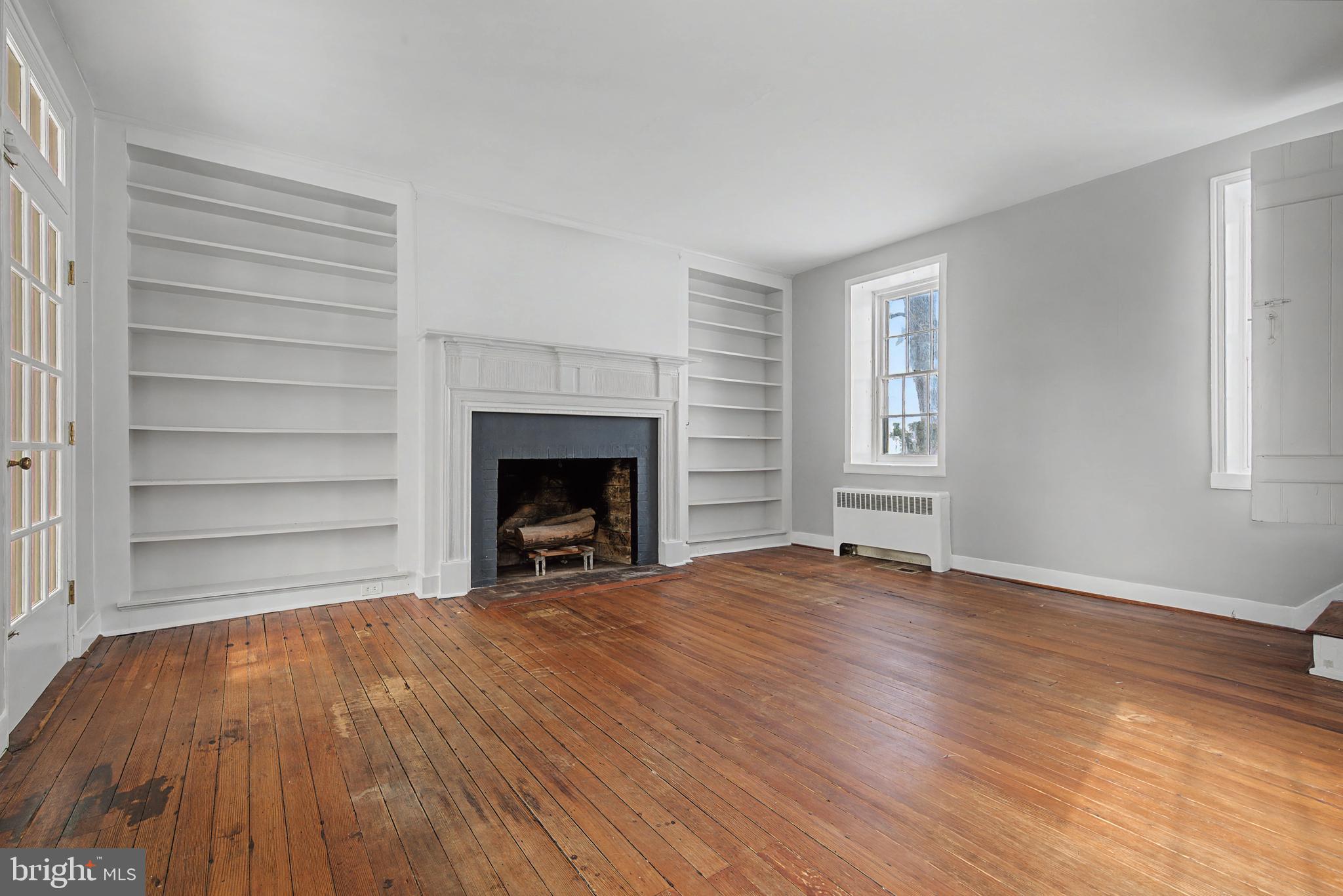 1776 Atlas Drive Frederick, MD 21702 - Photo 22 of 54 wooden floor fireplace and natural light in room