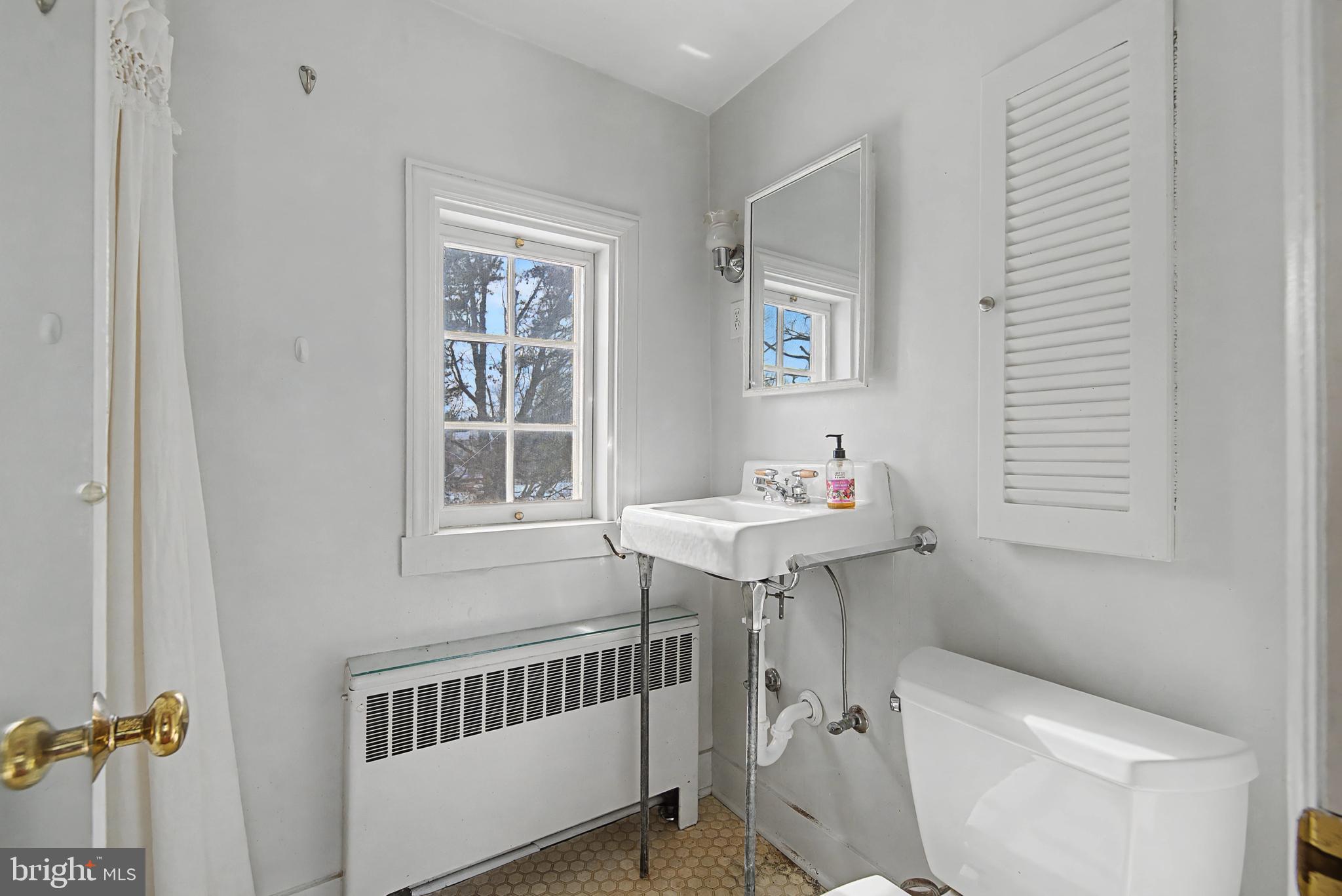 1776 Atlas Drive Frederick, MD 21702 - Photo 39 of 54 a bathroom with a sink toilet and a window