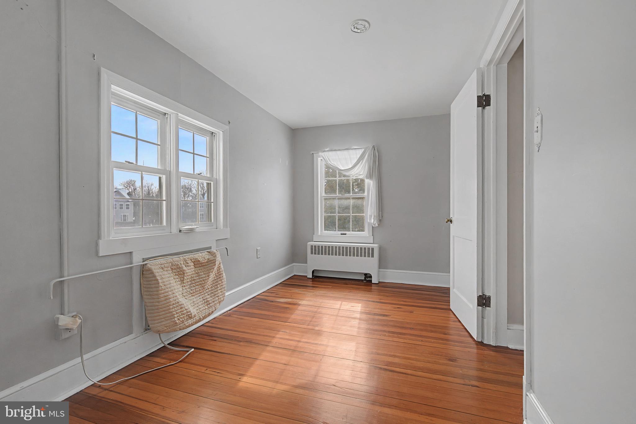 1776 Atlas Drive Frederick, MD 21702 - Photo 40 of 54 a view of an empty room with wooden floor and a window