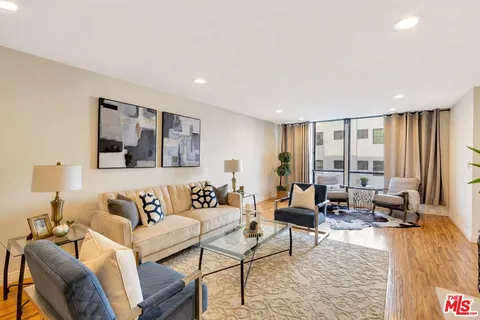 a living room with furniture and large windows