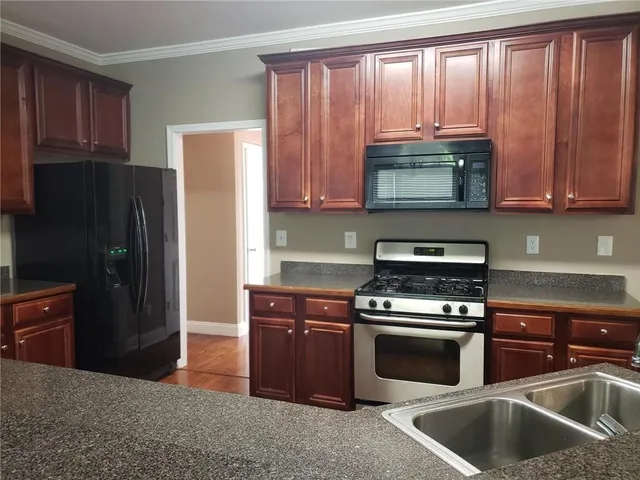 a kitchen with wooden cabinets and a stove top oven