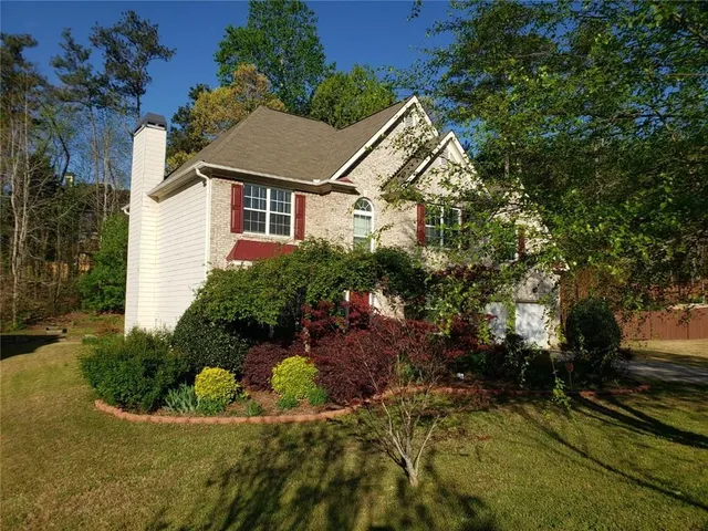 a aerial view of a house with a yard and potted plants