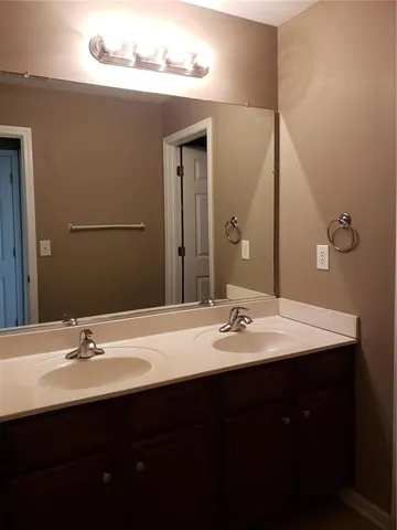 a bathroom with a double vanity sink and a mirror