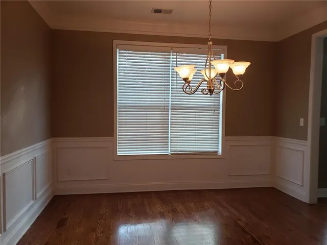 a view of a room with wooden floor and a window