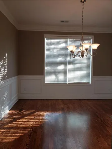 a view of a room with wooden floor and windows