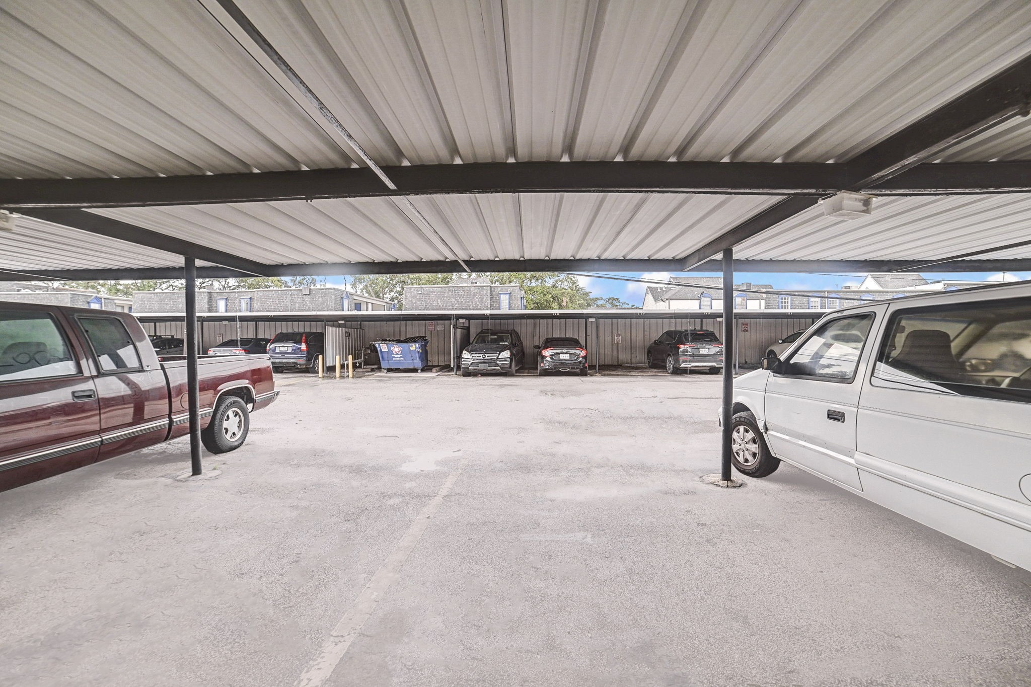 7900 Westheimer Road, Unit 202 Houston, TX 77063 - Photo 25 of 25 Covered parking area offering protection from the elements, accommodating multiple vehicles in a secure setting.