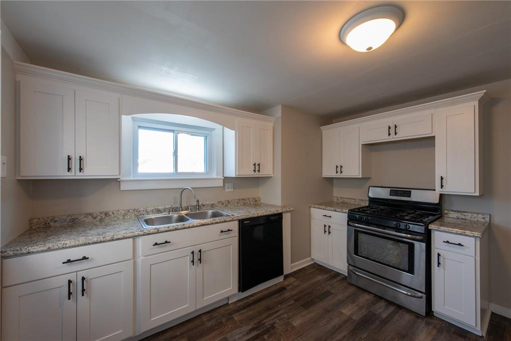 112 Farragut Avenue Vandergrift, PA 15690 - Photo 11 of 36 a kitchen with granite countertop a sink cabinets and stainless steel appliances