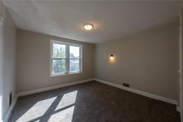 an empty room with a empty space and a window