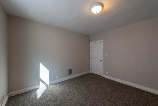 an empty room with a empty space and windows