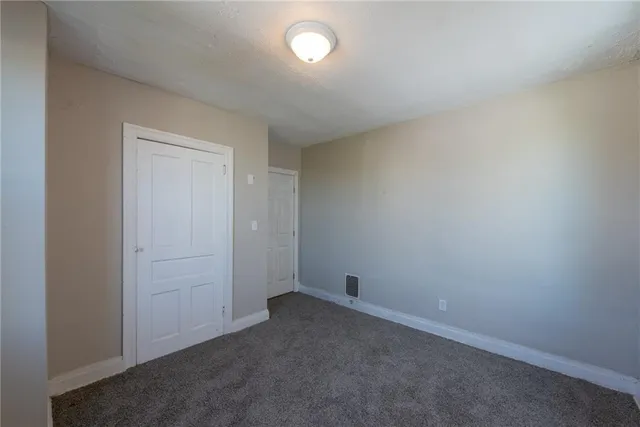 an empty room with a fan