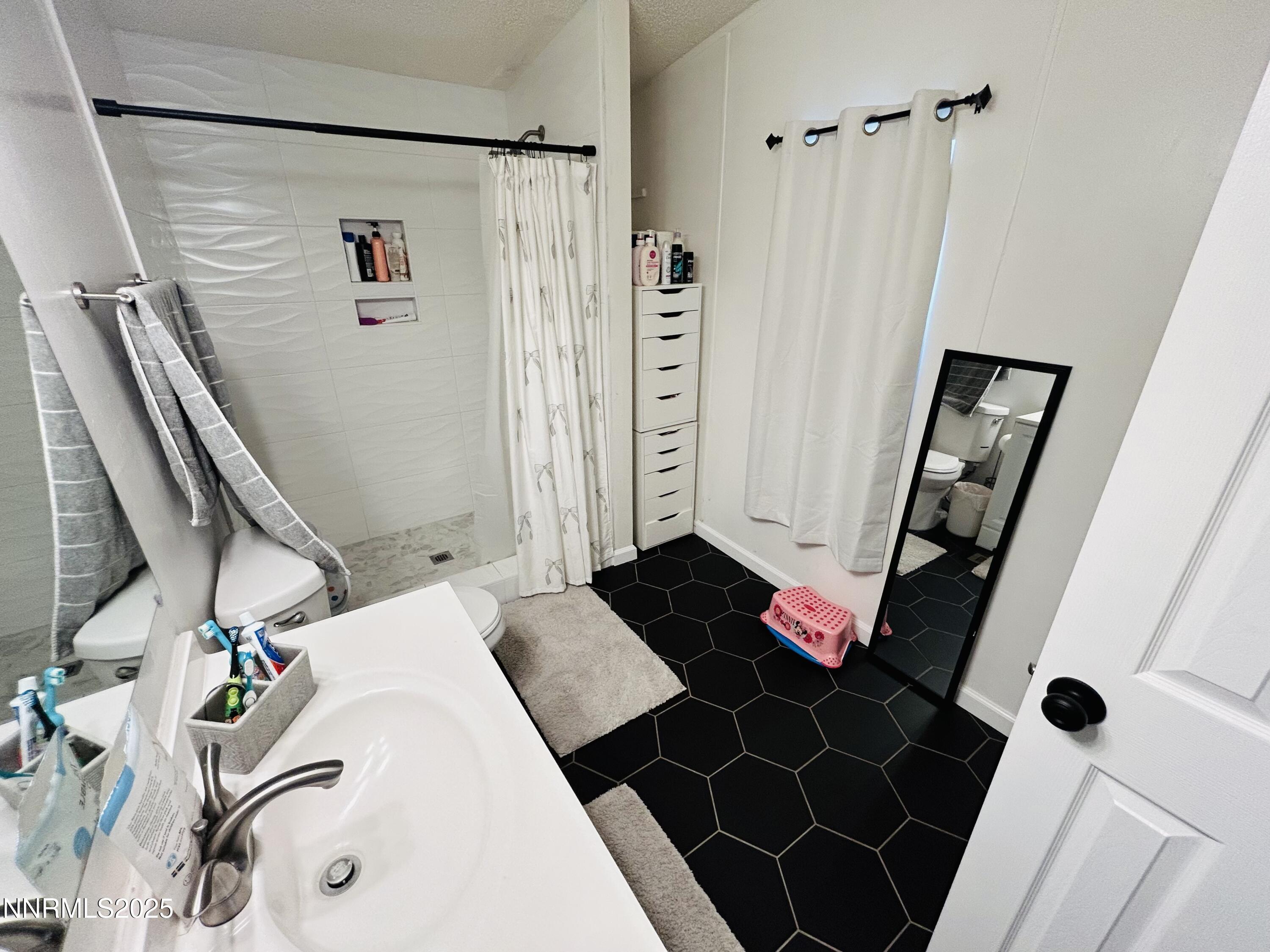 16 Stope Road Dayton, NV 89403 - Photo 17 of 21 a bedroom with a rug and a mirror