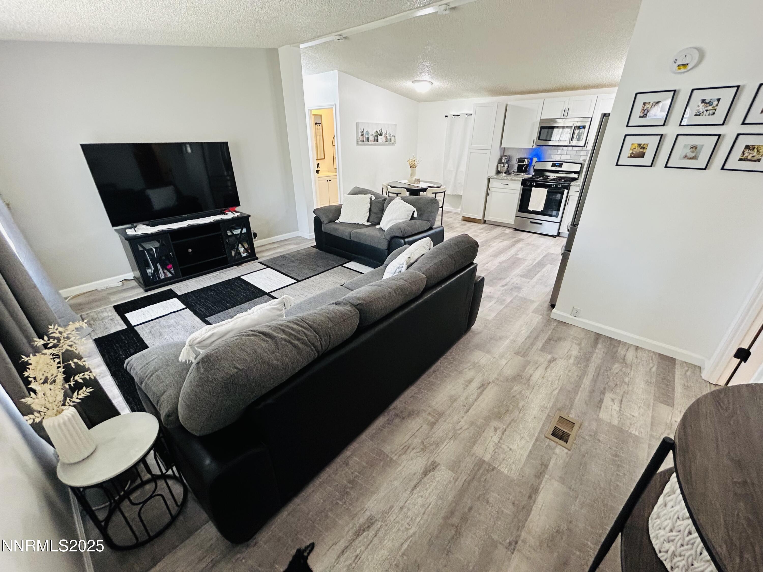 16 Stope Road Dayton, NV 89403 - Photo 7 of 21 a living room with furniture and a flat screen tv