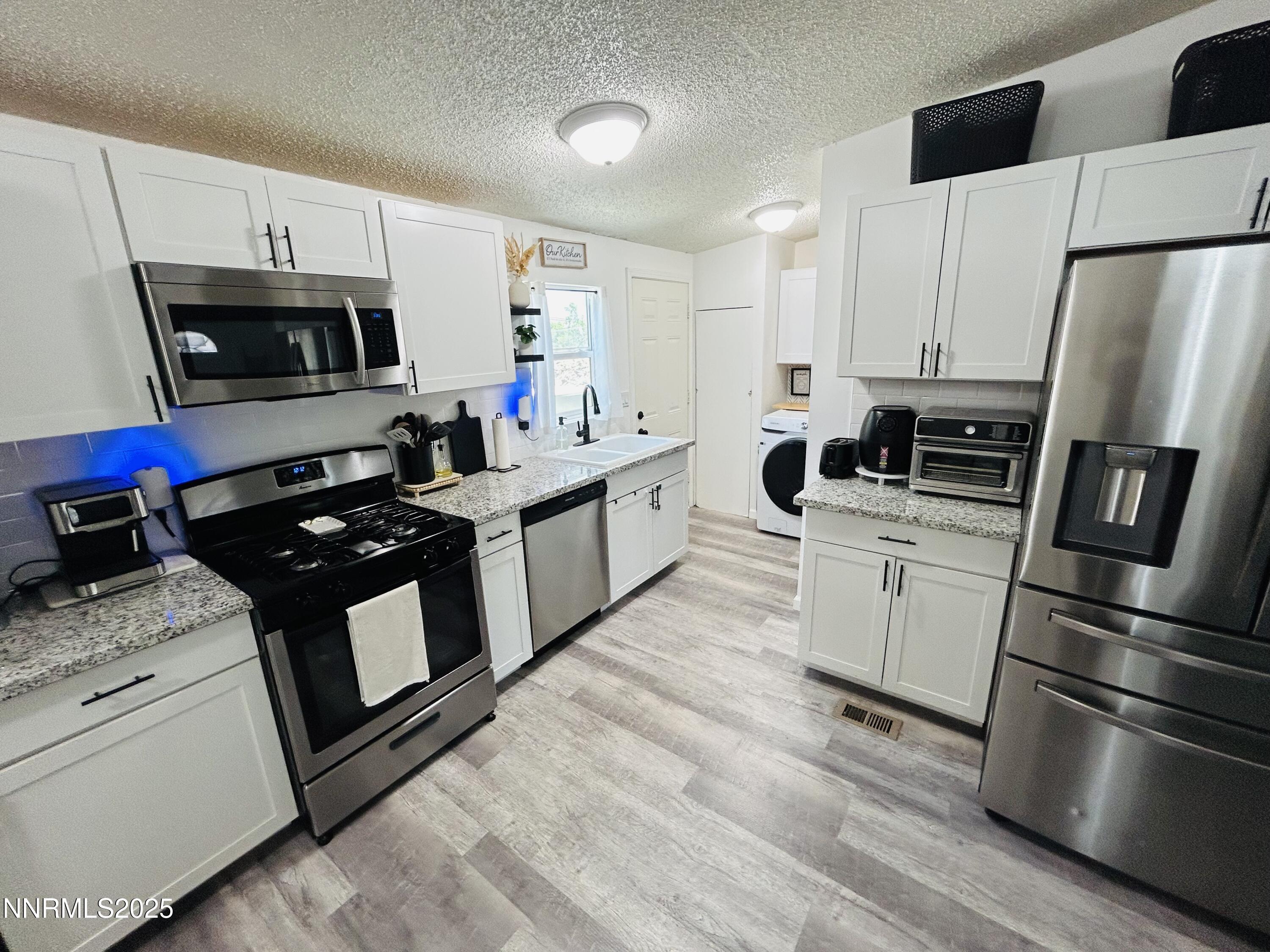 16 Stope Road Dayton, NV 89403 - Photo 10 of 21 a kitchen with a stove refrigerator and microwave