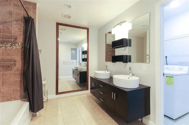 a spacious bathroom with a double vanity sink and a mirror