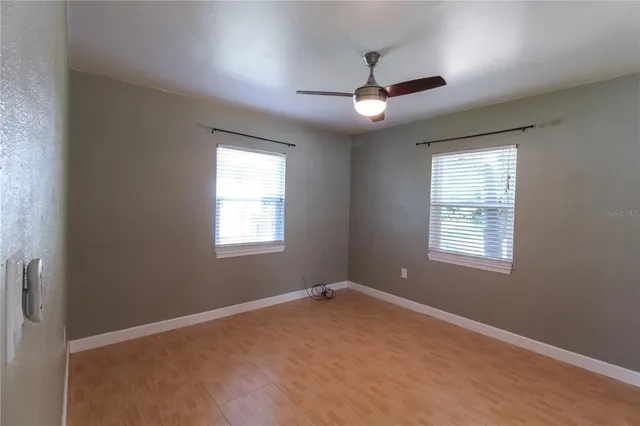 a view of a livingroom with a ceiling fan and window