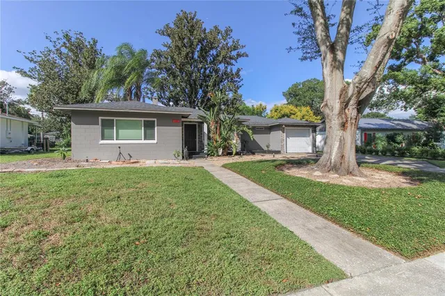 a front view of house with yard and green space