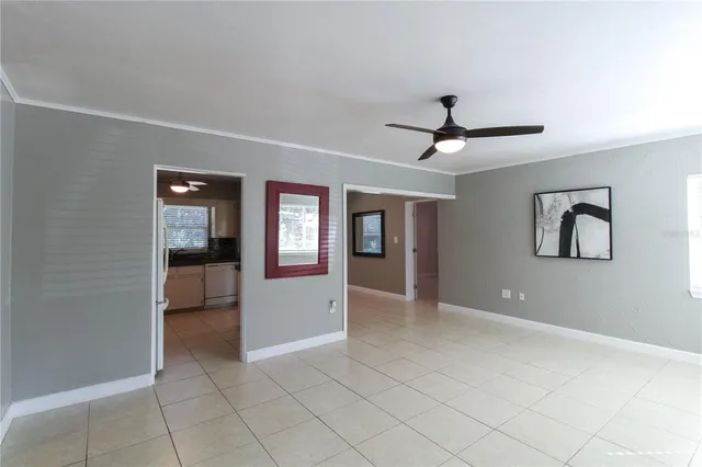 a view of a livingroom with a ceiling fan and window