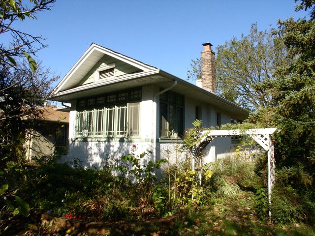 376 Addison Road Riverside, IL 60546 - Photo 18 of 18 a backyard of a house with table and chairs and potted plants