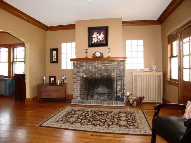 376 Addison Road Riverside, IL 60546 - Photo 3 of 18 a living room with furniture a rug a fireplace and windows