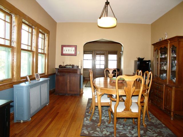 376 Addison Road Riverside, IL 60546 - Photo 6 of 18 a dining room with furniture a chandelier and wooden floor