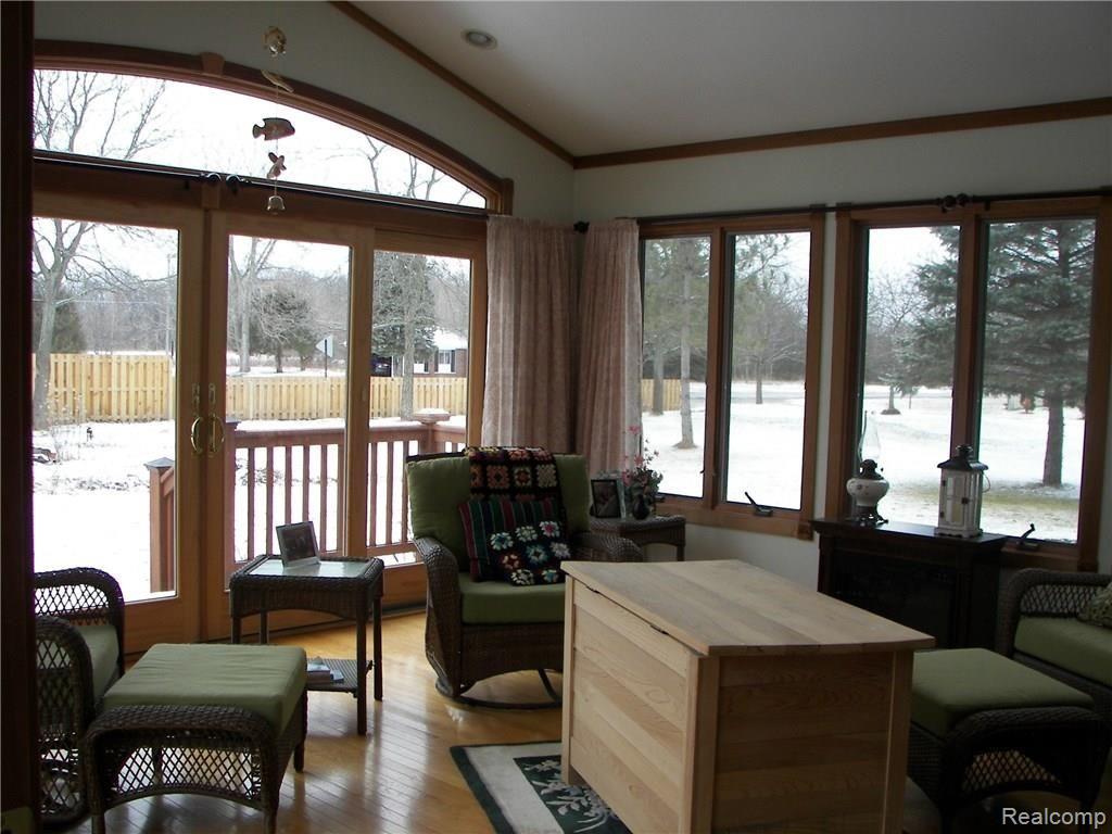 6788 Kestrel Ridge Road Brighton, MI 48116 - Photo 7 of 18 Four seasons room with skylights and windows on three sides. Walk out on the deck with your morning coffee. Retractable awning with remote.