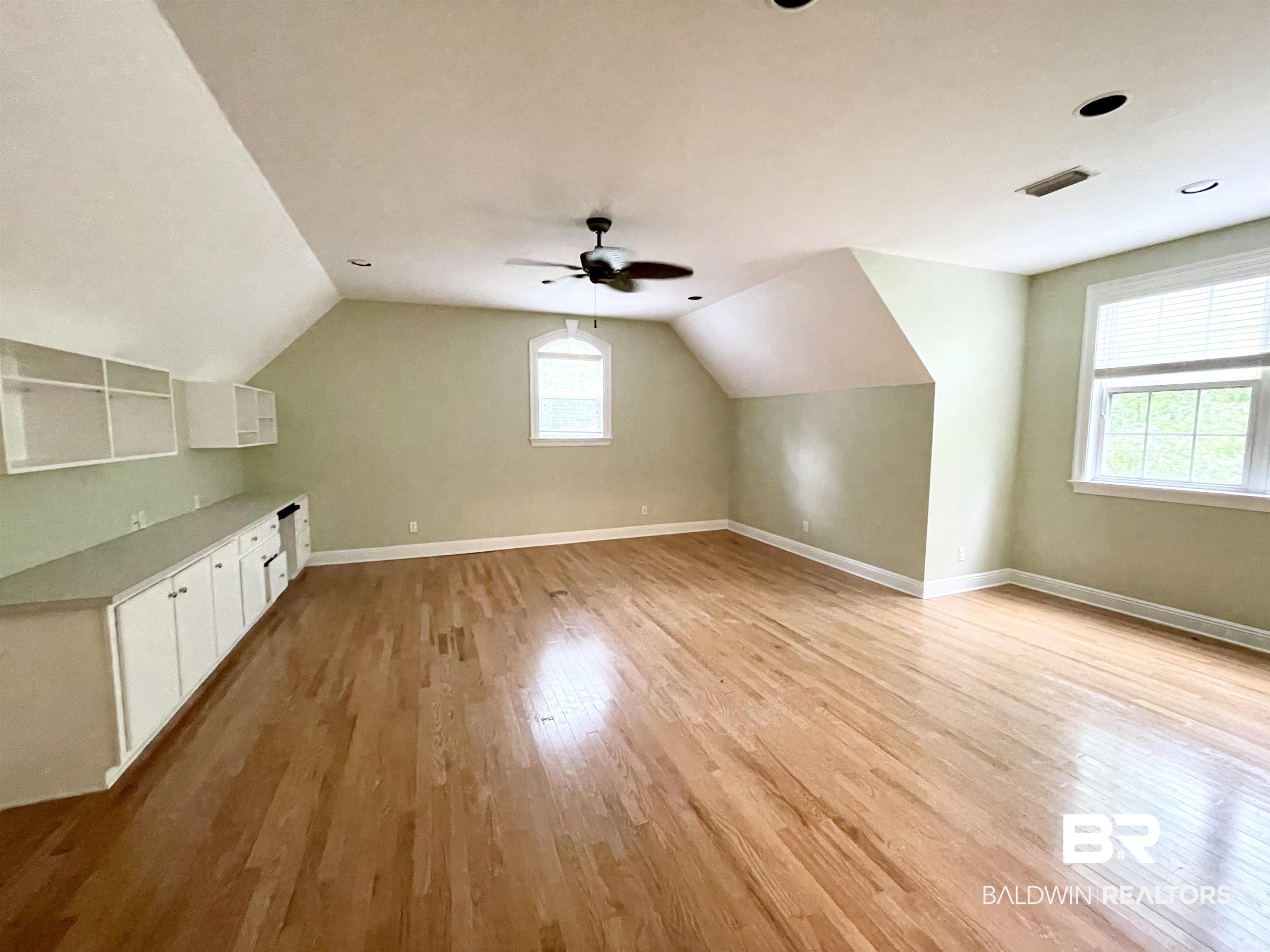202 Potters Mills Road Daphne, AL 36526 - Photo 21 of 29 Additional living space featuring real hardwood floors, built-ins, and plenty of natural light