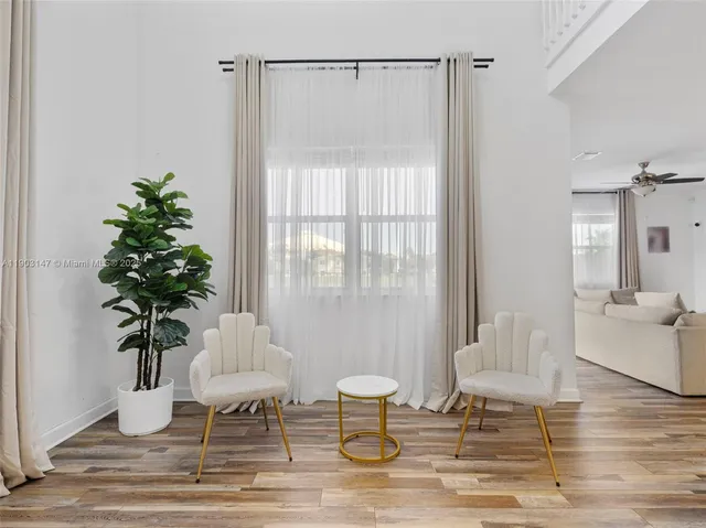 a view of a livingroom with furniture and a flat screen tv