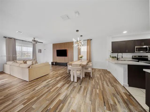 a view of a dining room with furniture and wooden floor