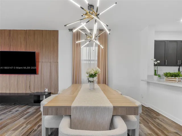 a view of a dining room with furniture and chandelier