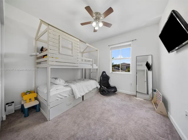 a spacious bedroom with a bed and a chandelier