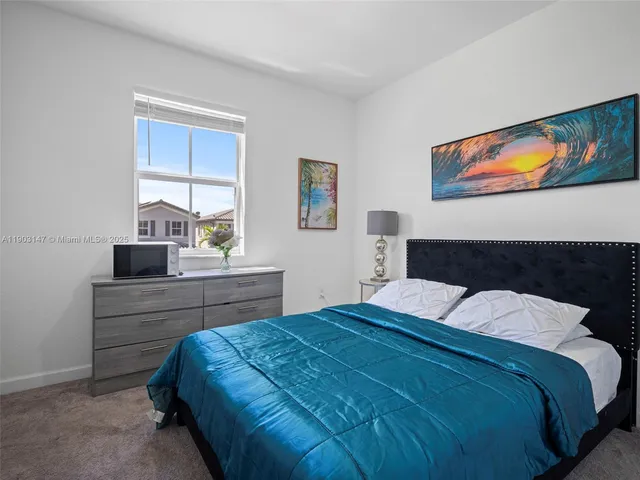 a bedroom with a bed and a potted plant