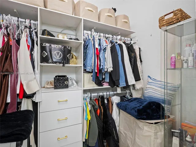 a front view of a house with a garden and palm trees