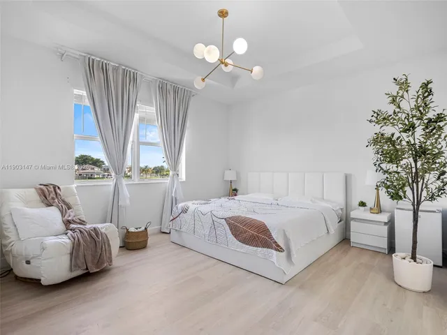 an aerial view of a city with lots of residential buildings ocean and mountain view