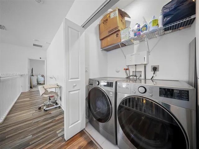 a view of a house with a big yard and large trees