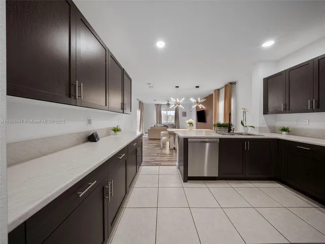 a view of a patio with couches table and chairs with wooden fence