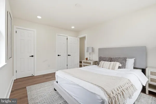 a bedroom with a large bed and a chandelier